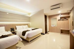 Ένα ή περισσότερα κρεβάτια σε δωμάτιο στο Hotel holitel