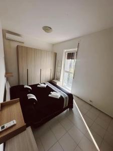 a bedroom with a bed in a room with a window at sole in Novara