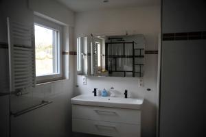 a white bathroom with a sink and a mirror at Rothaarsteig Ferienhaus in Kirchhundem +50 photos