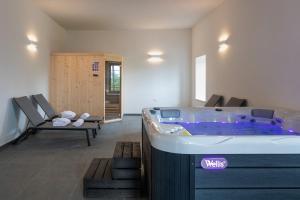 a hot tub in a living room with a chair at Villa Nene in Pićan +20 photos