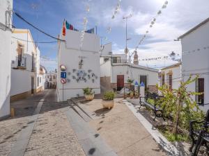a street with benches and a building with lights at Apartment in Peñaflor with Charming Patio in Peñaflor