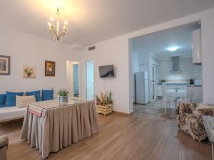 a living room with a couch and a table at Apartment in Peñaflor with Charming Patio in Peñaflor