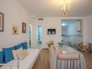 a living room with a couch and a table at Apartment in Peñaflor with Charming Patio in Peñaflor