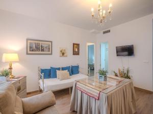 a living room with a couch and a table at Apartment in Peñaflor with Charming Patio in Peñaflor