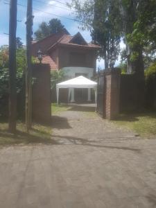 a house with a white umbrella in front of it at El bosque suite in José León Suárez