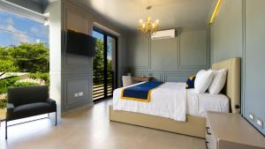 a bedroom with a bed and a chair and a television at Hotel Tiffany in Flores +12 photos