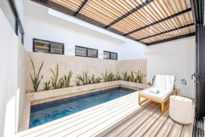 einen Pool in der Mitte einer Terrasse mit einem Stuhl in der Unterkunft Casa Peace with salt water pool 4BR 4BR in Tamarindo