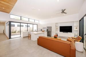 ein Wohnzimmer mit Sofa und Fernseher in der Unterkunft Casa Peace with salt water pool 4BR 4BR in Tamarindo