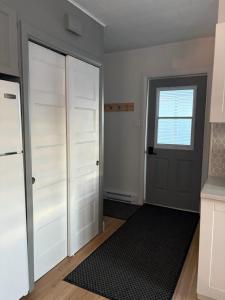 a room with white closet doors and a window at Maison d edouard in Saint-Antonin