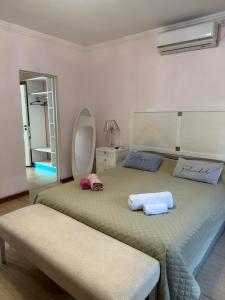 a bedroom with a large bed with two towels on it at La Bendita in Posadas
