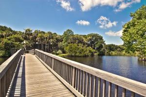 a wooden pedestrian bridge over a river with trees at SM04: 4 Silver Moss in Kiawah Island
