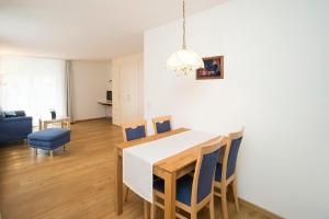 a kitchen and dining room with a table and chairs at Chesa Quadrella in Pontresina