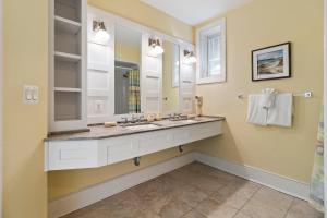 a bathroom with a sink and a mirror at SS52: 52 Surfsong in Kiawah Island +58 photos