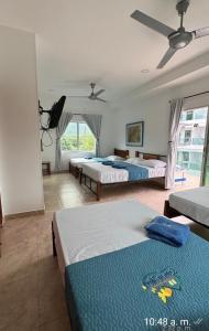 a bedroom with two beds and a large window at Casa de Mony in Santa Marta +171 photos