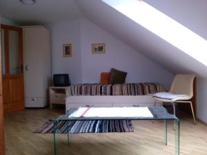 a living room with a couch and a table at Fügefa Vendégház in Orfű