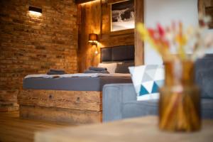 a row of beds in a room with a brick wall at Pension U Studny in Harrachov