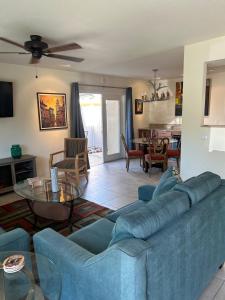 a living room with a blue couch and a table at Rancho Mirage Gem! 90 day-bookings only in Rancho Mirage