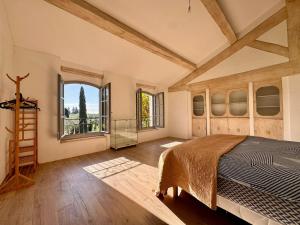 a bedroom with a bed and a large window at Mas d Anissa in Avignon +26 photos