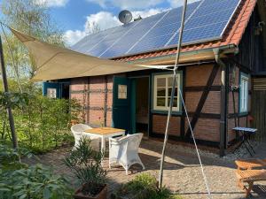 a house with solar panels on the roof at Großzügiges Studio In Einem Kleinen Fachwerkhaus in Dömitz