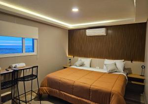 Ένα ή περισσότερα κρεβάτια σε δωμάτιο στο Ayres Dorados Lodge Hotel