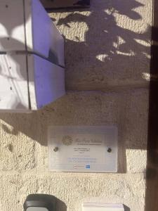 a plaque on a wall with a sign on it at Mini Home Valentina in Fasano