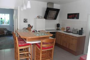 StollhammにあるFerienhaus In Stollhamm Mit Großem Gartenのテーブルと椅子が備わるキッチン