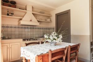 a kitchen with a table with a vase of flowers on it at Diana in Pesaro