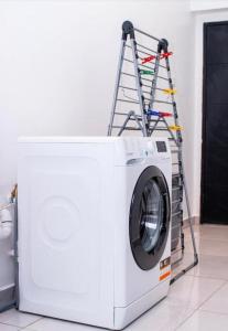 a washing machine with a ladder on top of it at Legacy Square Apartment in Accra +19 photos