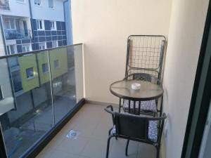 una mesa pequeña y una silla en el balcón en Apartman Vaske 2, en Brčko