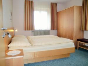 a bedroom with a large bed with a window at Wohnung In Den Dolomiten Mit Traumhafter Aussicht in Kastelruth