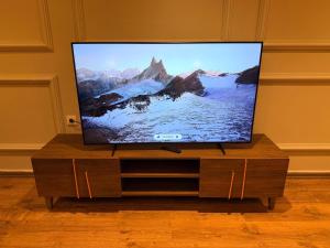 a flat screen tv sitting on top of a wooden entertainment center at Suite Bahiya 15 in Fès