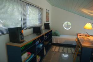 a bedroom with a bed and a desk with a computer at Cottage in Tiros