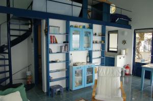 a room with a blue wall with shelves at Cottage in Tiros