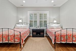a bedroom with two beds and a sink in it at SS162: 162 Surfsong Road in Kiawah Island +70 photos