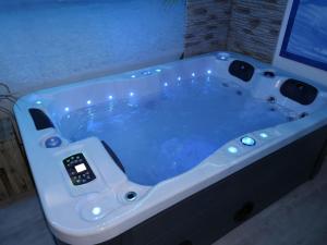 a large bath tub with an electronic device in it at Ferienwohnung Maaridyll In Schalkenmehren in Schalkenmehren