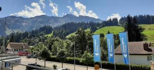 a view of the mountains from a parking lot with blue signs at Rothorn Center A 1Og Schöpfer in Sörenberg