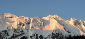 a snow covered mountain with a blue sky in the background at Rothorn Center A 1Og Schöpfer in Sörenberg +7 photos