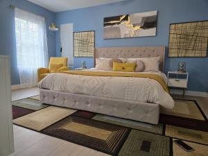 a bedroom with a large bed with blue walls at The Backwoods Paradise in Logan +71 photos