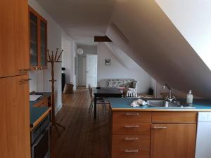 a kitchen with a sink and a table in a room at Thurø Kro B&B in Svendborg
