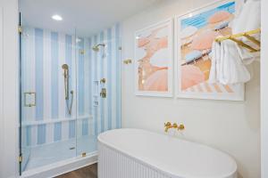 a bathroom with a shower and a white tub at WS4456: 4456 Windswept in Kiawah Island +41 photos