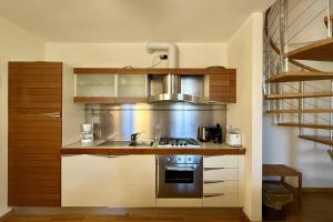 a kitchen with a sink and a stove at La Piazza Menaggio in Menaggio