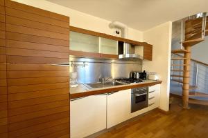a kitchen with a sink and a stove at La Piazza Menaggio in Menaggio