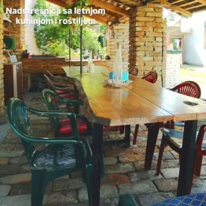Una mesa y sillas de madera en un patio. en STD Kod Makse, kuca na jezeru Kraljevac, en Deliblato