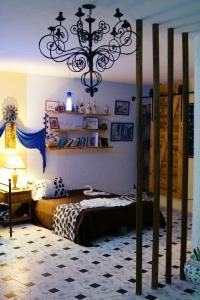 a bedroom with a bed and a chandelier at L'artisan in Hergla