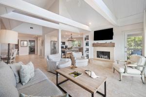 a living room with white furniture and a fireplace at SS3559: 3559 Seascape in Kiawah Island