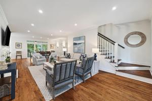 a living room filled with furniture and a staircase at OG18: 18 Ocean Green in Kiawah Island