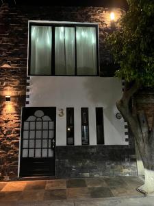 un edificio con puertas negras y una ventana en Stone laja, en Guadalajara