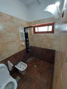 a small bathroom with a toilet and a window at Rincon de la Selva in La Calera +21 photos