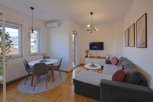 a living room with a couch and a table at Kosta Boutique Apartment in Banja Luka