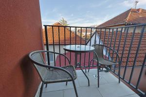 a patio with two chairs and a table on a balcony at Kosta Boutique Apartment in Banja Luka